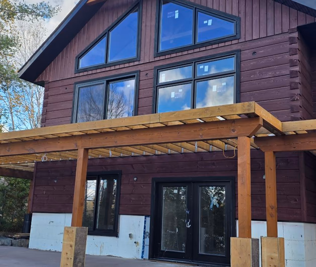 Restored log home with covered porch and fresh stain