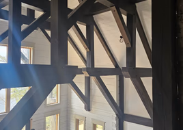 Large timber beams spanning a finished great room
