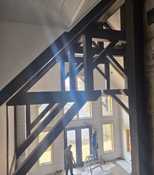 Interior timber beam overview with tall windows